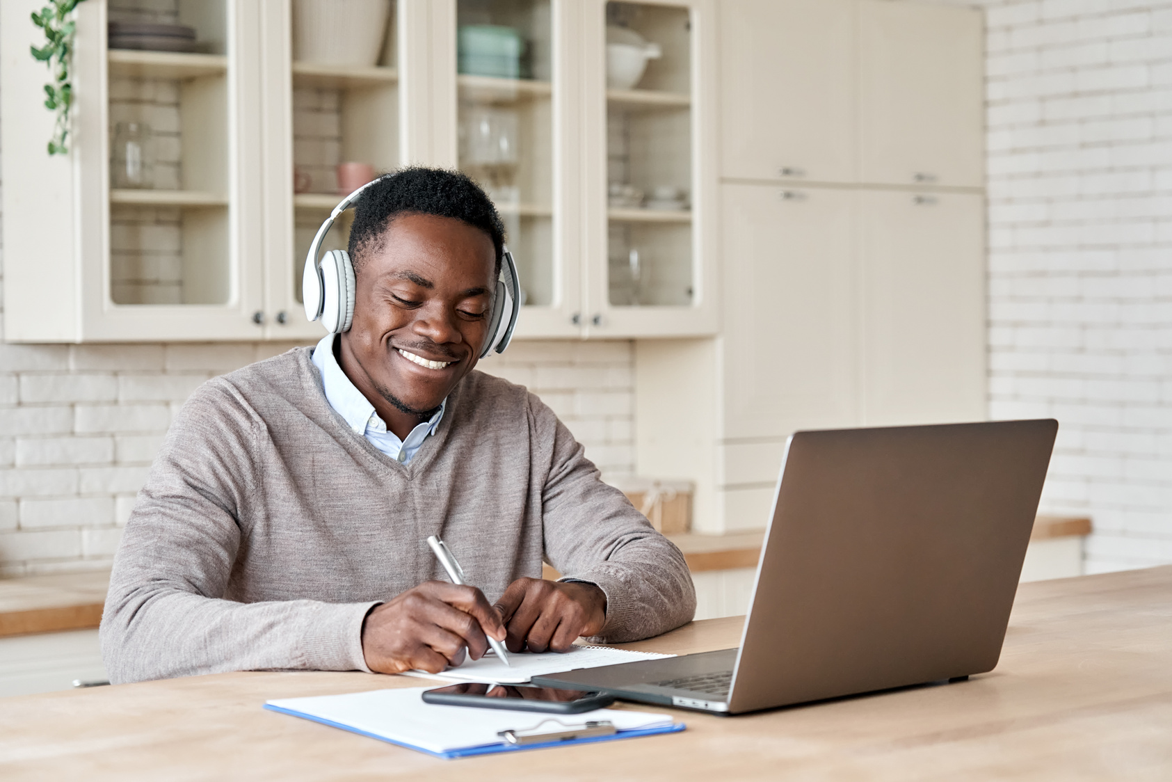 Male Student E-learning on Laptop at Home Office